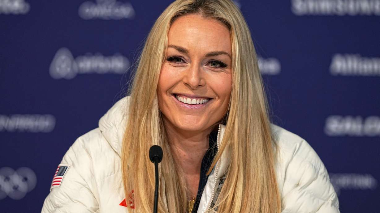 FILE - United States' Lindsey Vonn smiles during a press conference by the U.S. ski team at the 2026 Winter Olympics, in Cortina d'Ampezzo, Italy, Tuesday, Feb. 3, 2026.
