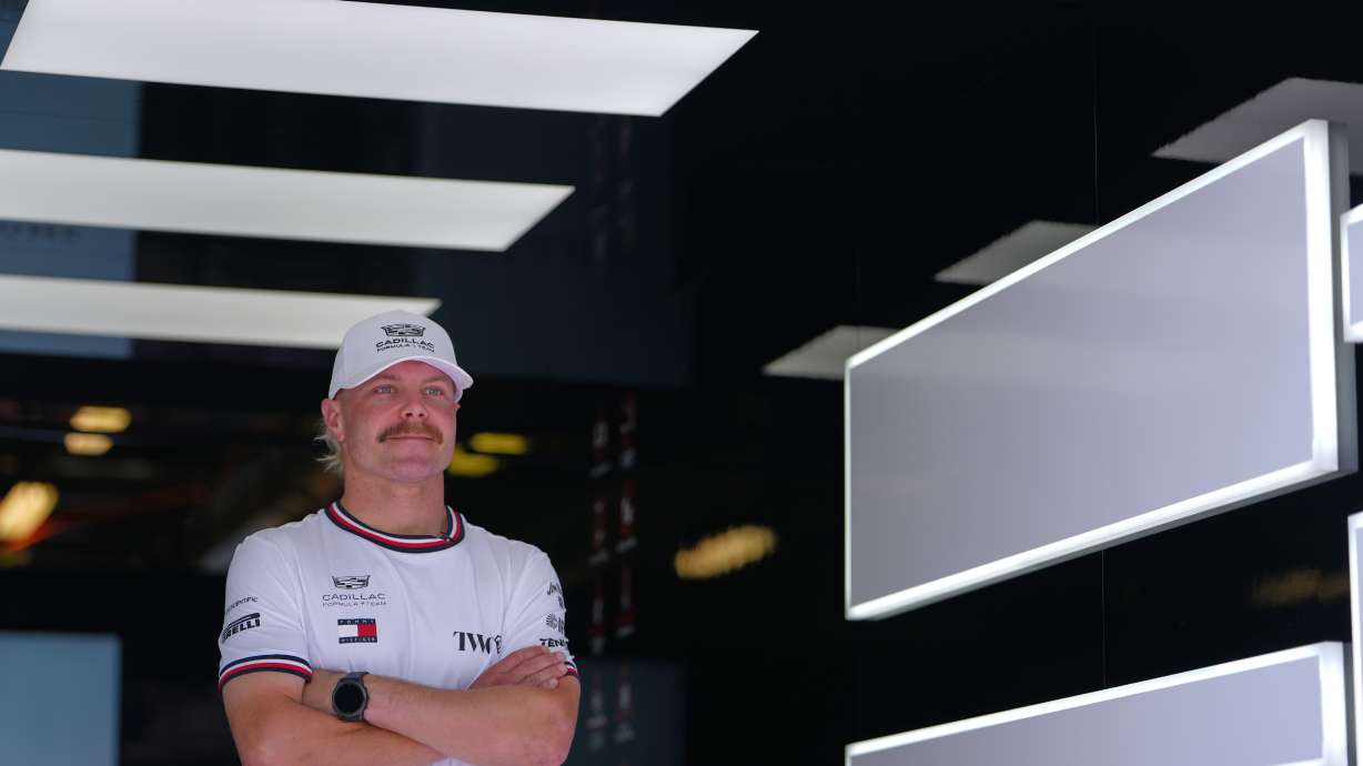 FILE - Cadillac driver Valtteri Bottas, of Finland, poses in his team garage ahead of the Australian Formula One Grand Prix at Albert Park, in Melbourne, Australia, Thursday, March 5, 2026.