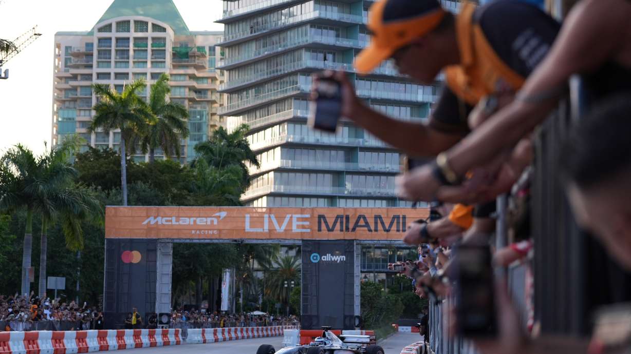 Fans watch as former Brazilian racing driver Bruno Senna steers an MP4/6 during a fan event showcasing past McLaren race cars ahead of the Formula One Miami Grand Prix auto race, Wednesday, April 29, 2026, in the Coconut Grove area of Miami.