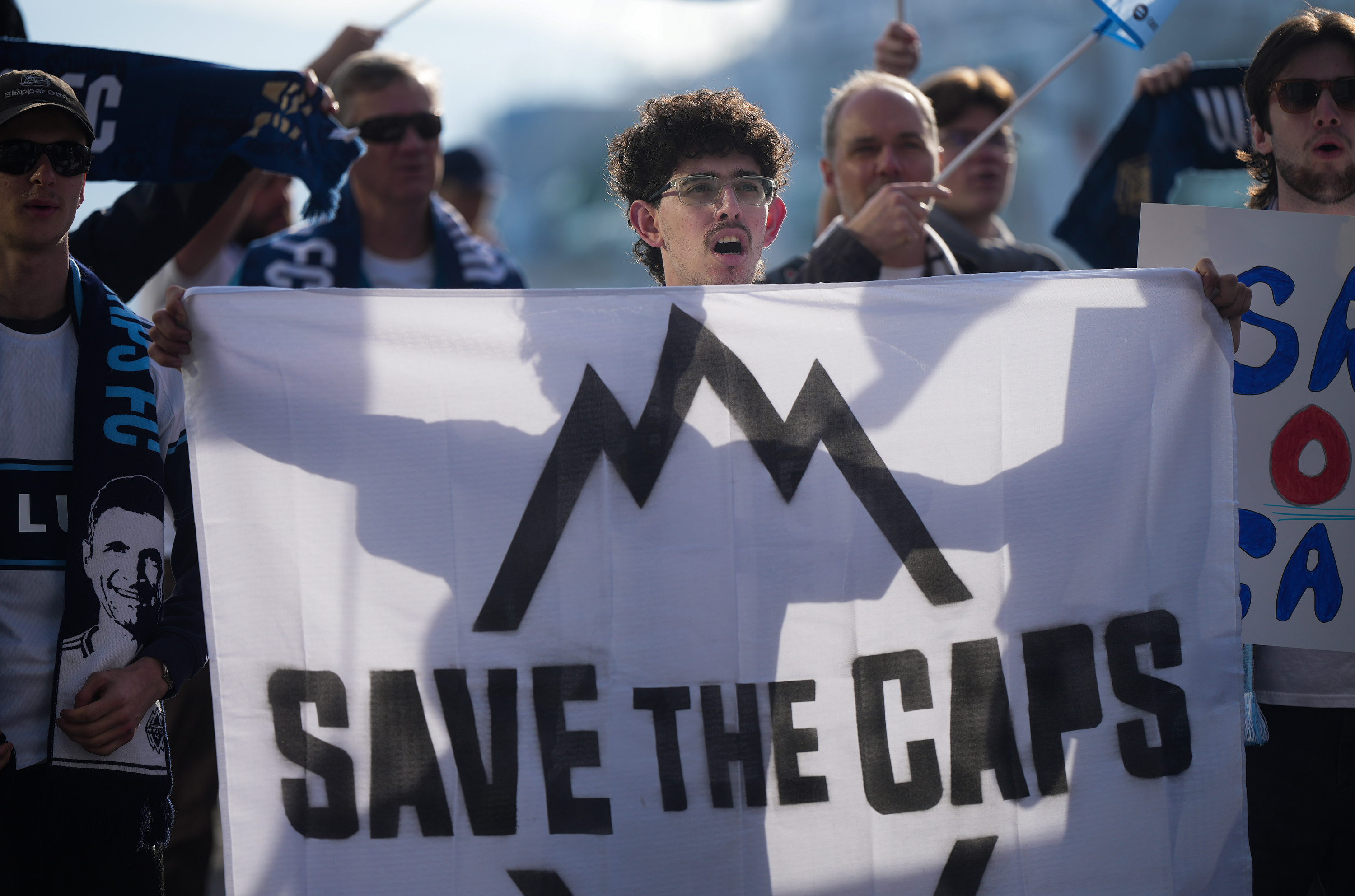 Fans of the Vancouver Whitecaps MLS soccer team rally to keep the team in Vancouver, Thursday, April 30, 2026, outside the 76th FIFA Congress in Vancouver, British Columbia.