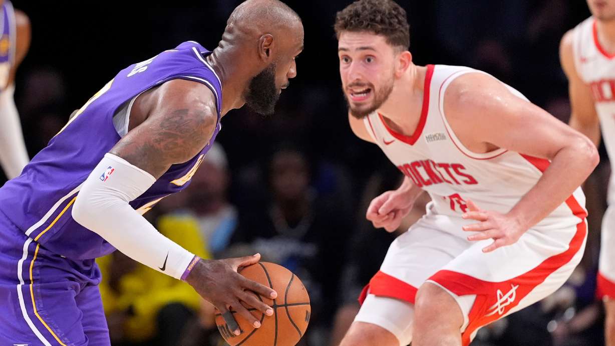 Los Angeles Lakers forward LeBron James, left, tries to get by Houston Rockets center Alperen Sengun during the second half in Game 5 of a first-round NBA playoffs basketball series Wednesday, April 29, 2026, in Los Angeles.