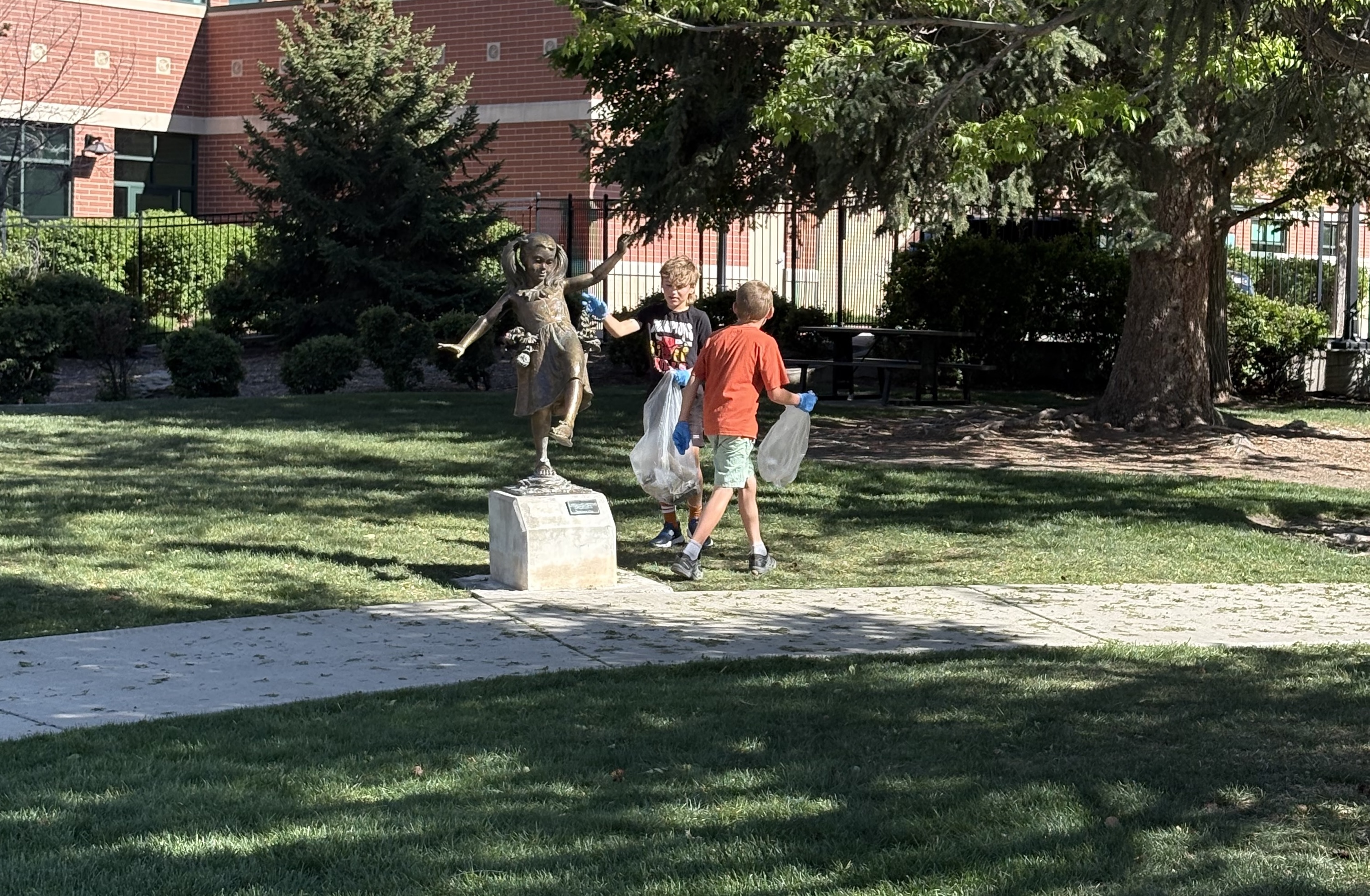 Kids from the Cool Cleaning Crew pick up trash at Splash Pad Park in Springville on April 23, 2026.