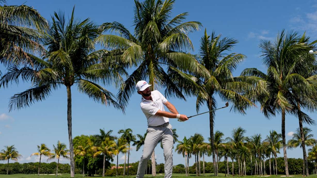 Cameron Young hits along the cart path on the first fairway during the first round of the Cadillac Championship PGA golf tournament Thursday, April 30, 2026, in Doral, Fla.