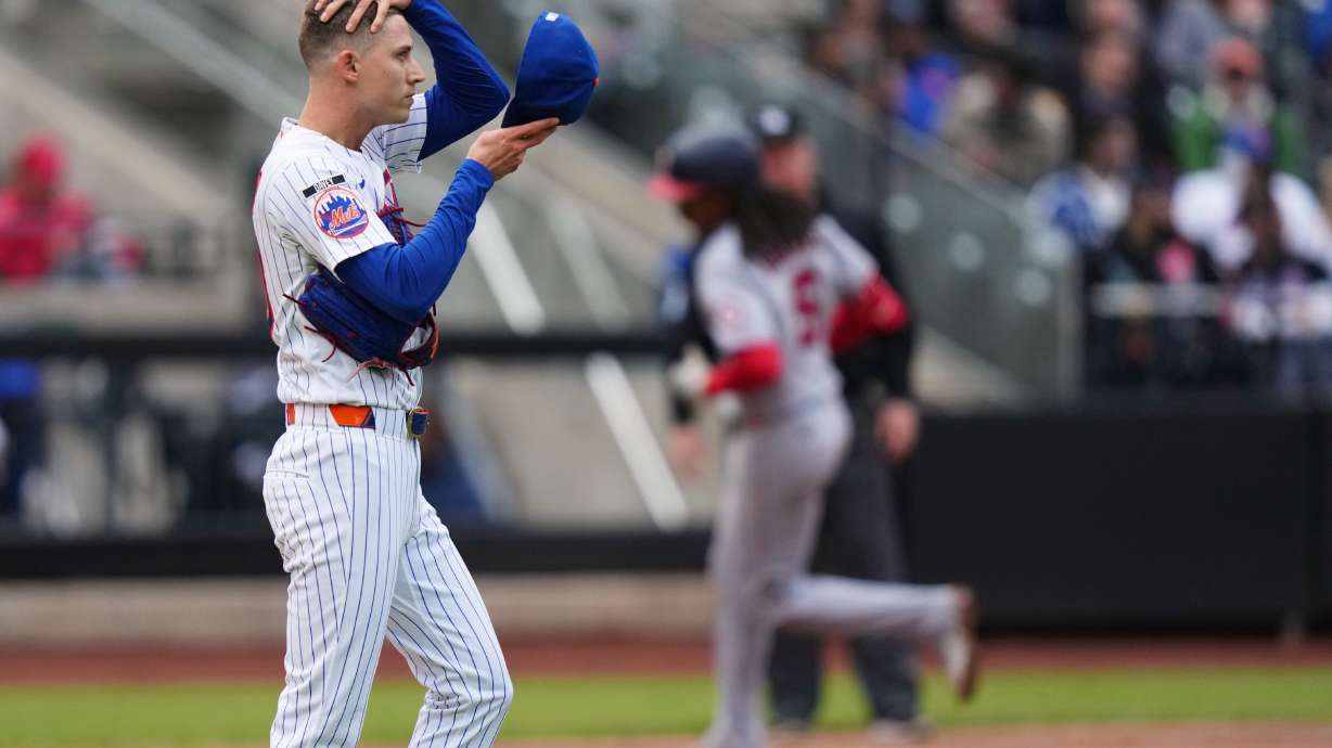 New York Mets pitcher Luke Weaver, left, reacts as Washington Nationals' CJ Abrams runs the bases after hitting a two run home run during the eighth inning of a baseball game Thursday, April 30, 2026, in New York.