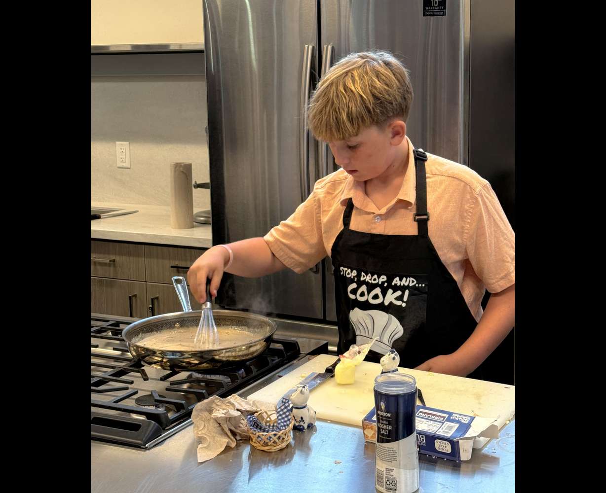 Salt Lake teen Merrill Oaks cooks pork chops for a youth cook-off at the Utah State Fair in September 2025.