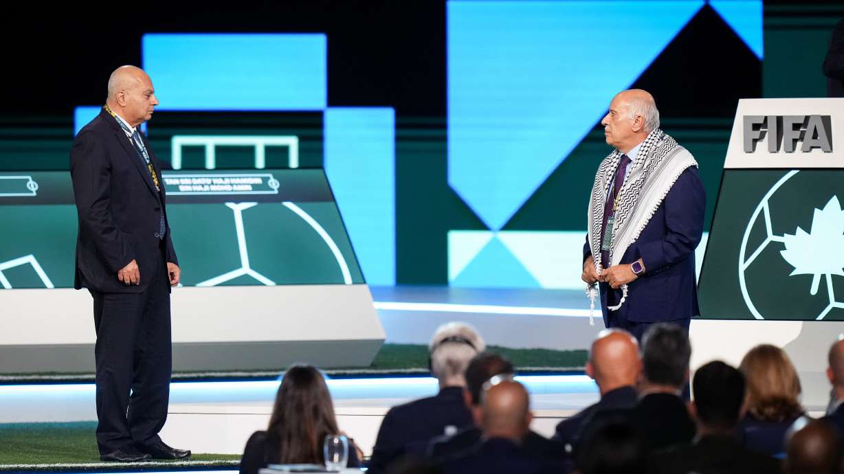 Palestinian Football Association President Jibril Rajoub, right, refuses to stand together with Israel Football Association Vice-President Basim Sheikh Suliman, left, after FIFA President Gianni Infantino, not seen, tried to bring them together during the 76th FIFA Congress in Vancouver, British Columbia, Thursday, April 30, 2026.