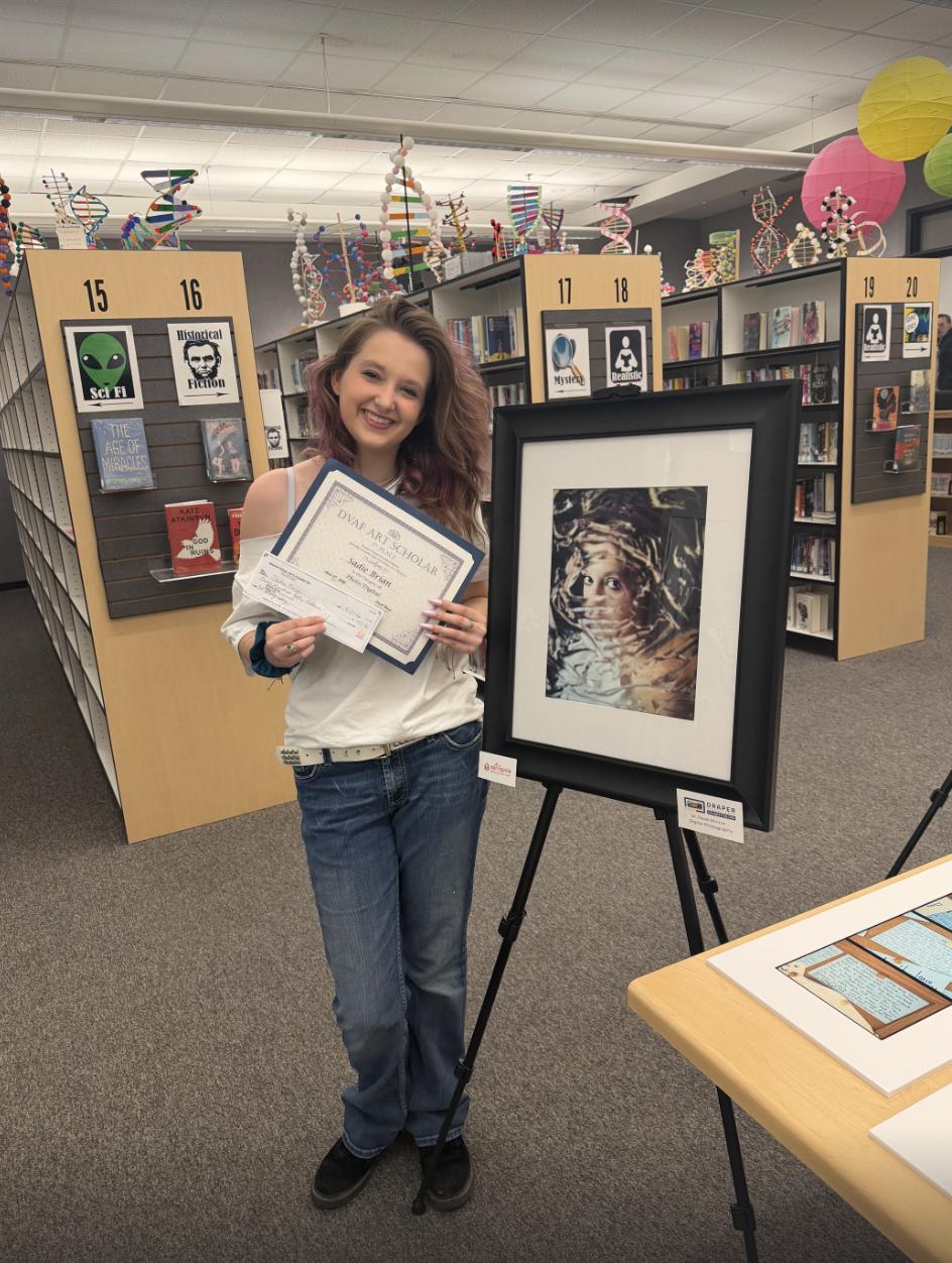 Sadie Brian poses with her photography art submission in the Draper Visual Arts Foundation's arts scholar competition. Brian, a senior at Alta High, won first place in photography for her entry titled "My Soul" during an awards ceremony at Draper City Hall on Monday.