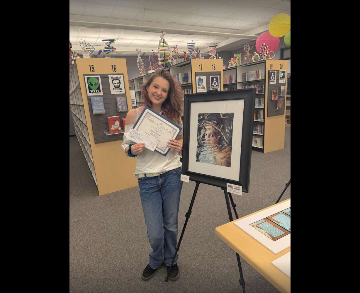Sadie Brian poses with her photography art submission in the Draper Visual Arts Foundation's arts scholar competition. Brian, a senior at Alta High, won first place in photography for her entry titled "My Soul" during an awards ceremony at Draper City Hall on Monday.