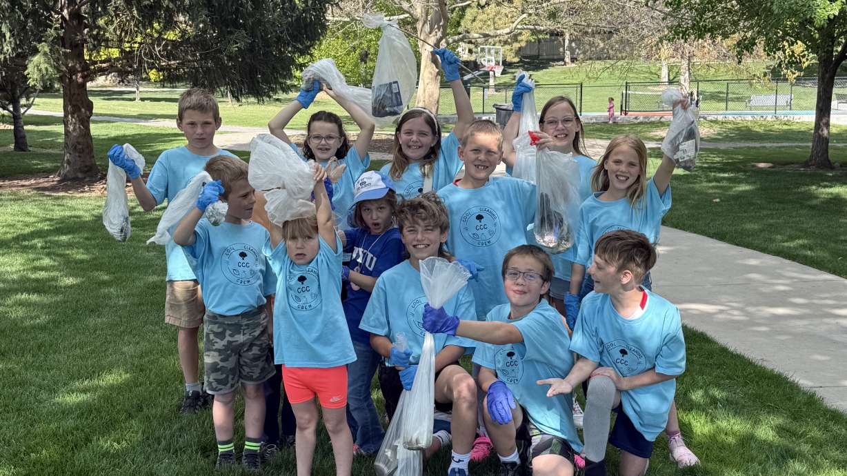 The club poses for a photo while picking up trash at Spring Creek Park in Springville on Thursday.