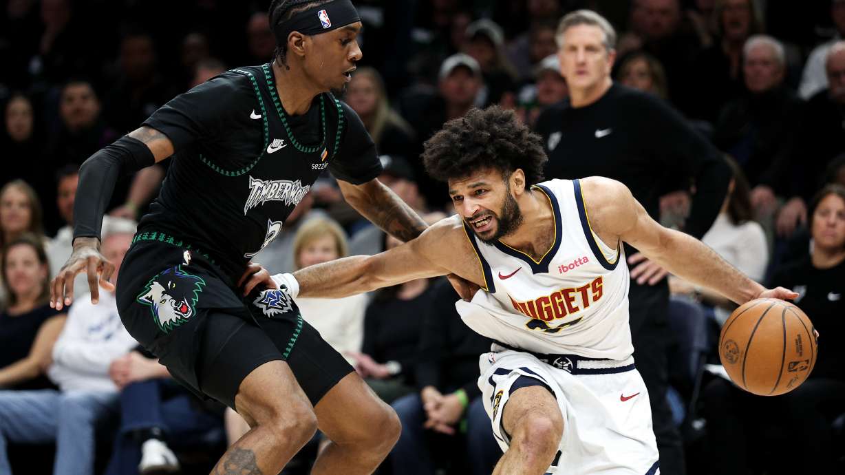 Denver Nuggets guard Jamal Murray, right, controls the ball as Minnesota Timberwolves forward Jaden McDaniels, left, defends during the first half of Game 6 of a first-round NBA basketball playoffs series, Thursday, April 30, 2026, in Minneapolis.