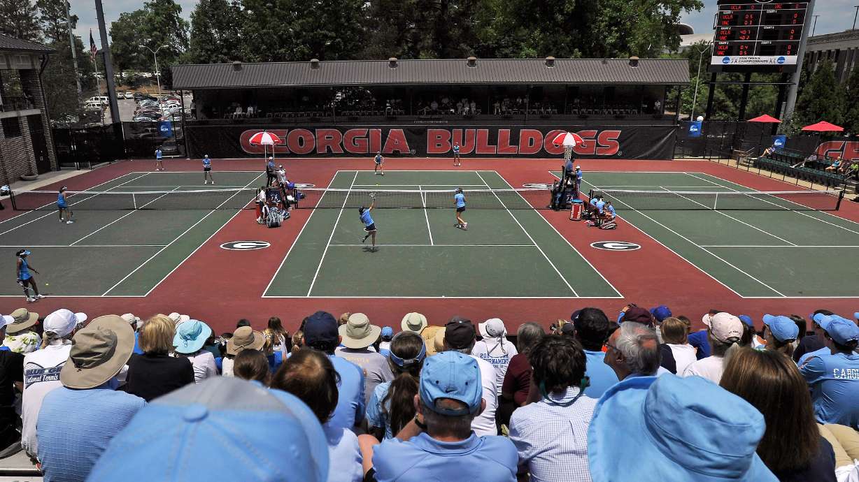 FILE - Spectators crowd center court at the Dan Magill Tennis Complex during the UCLA and North Carolina women's doubles match in the NCAA Division I tennis championships, May 20, 2014, in Athens, Ga.