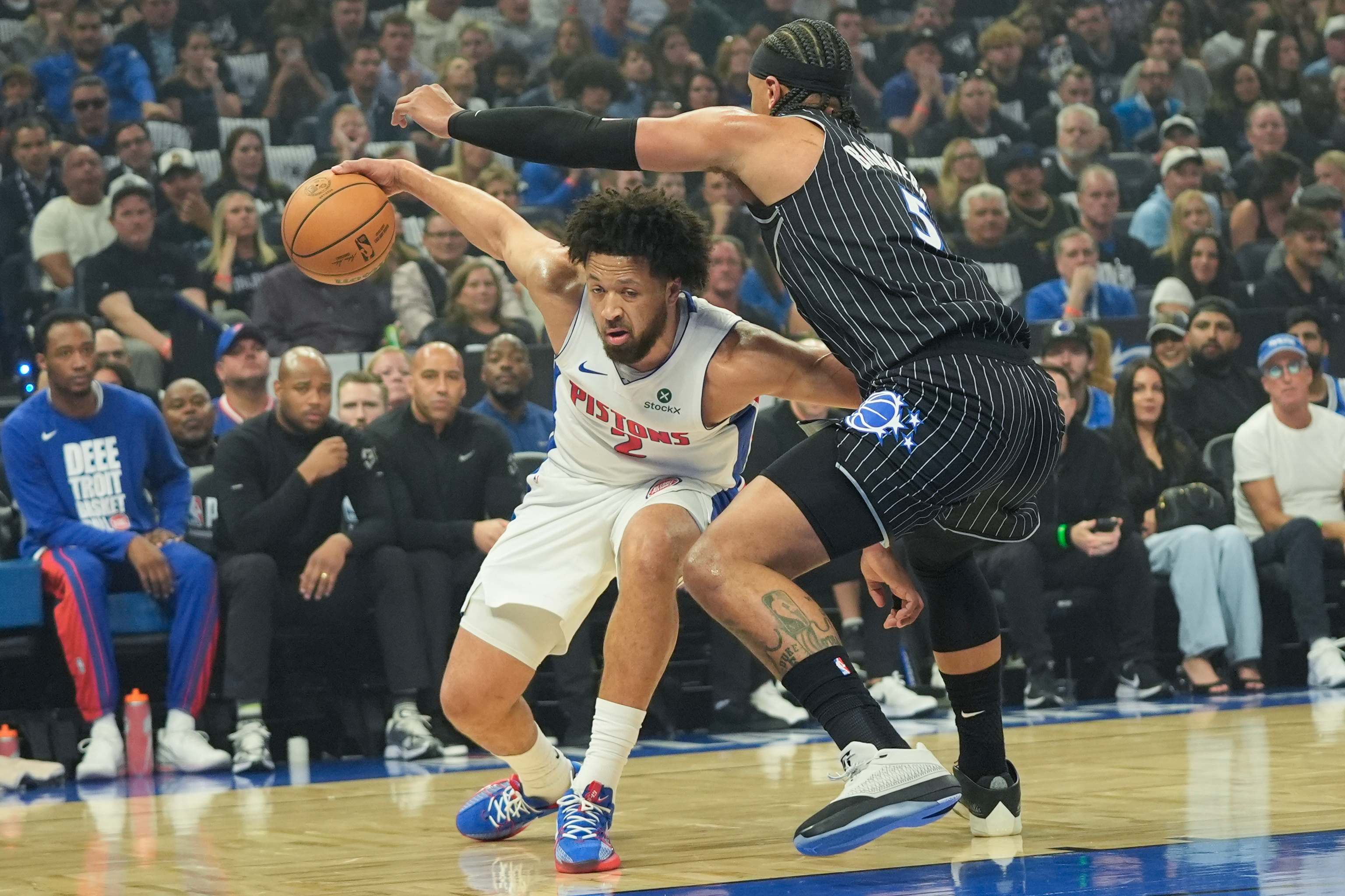 Detroit Pistons guard Cade Cunningham, left, tires to get past Orlando Magic forward Paolo Banchero, right, during the first half in Game 6 of a first-round NBA basketball playoffs series, Friday, May 1, 2026, in Orlando, Fla.