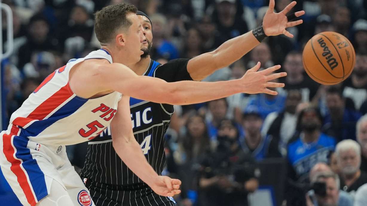 Detroit Pistons forward Duncan Robinson, left, passes the ball against Orlando Magic guard Jalen Suggs (4) during the second half in Game 6 of a first-round NBA basketball playoffs series, Friday, May 1, 2026, in Orlando, Fla.