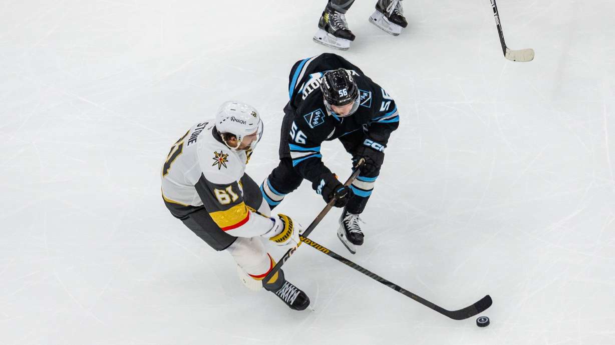 Vegas Golden Knights right wing Mark Stone (61) and Utah Mammoth right wing Kailer Yamamoto (56) fight for the puck during Game 6 of a first-round NHL Stanley Cup playoff series at the Delta Center in Salt Lake City on Friday, May 2, 2026.