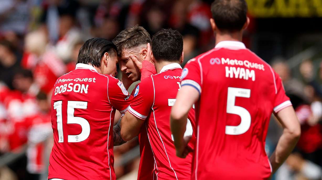 Wrexham's Josh Windass, second left, celebrates scoring his side's first goal of the game with teammates, during the EFL Championship soccer match between Wrexham and Middlesbrough, in Wrexham, Wales, Saturday May 2, 2026.