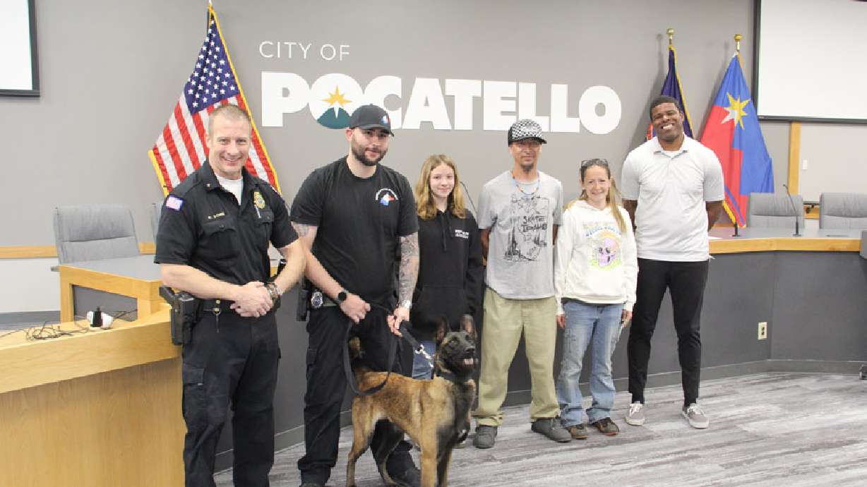 Pocatello Police Chief Roger Schei, Cpl. Brendan Howard, Burniece Dustin, Danny Dustin, Danniell Dustin and Lt. Akilah Lacey stand with K-9 Boo. Boo was slated for euthanasia before Dustin' Time Rescue took her in and trained her.