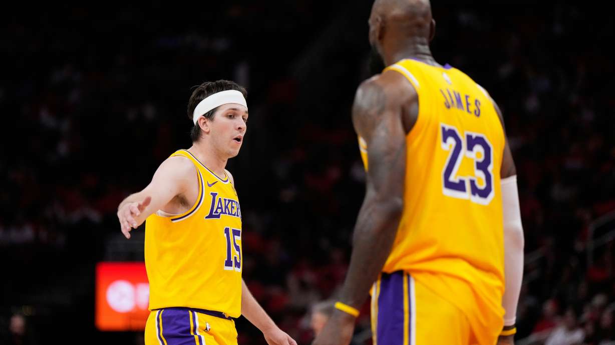 Los Angeles Lakers guard Austin Reaves (15) celebrates with forward LeBron James (23) during the second half of Game 6 of a first-round NBA playoffs basketball series against the Houston Rockets in Houston, Friday, May 1, 2026.