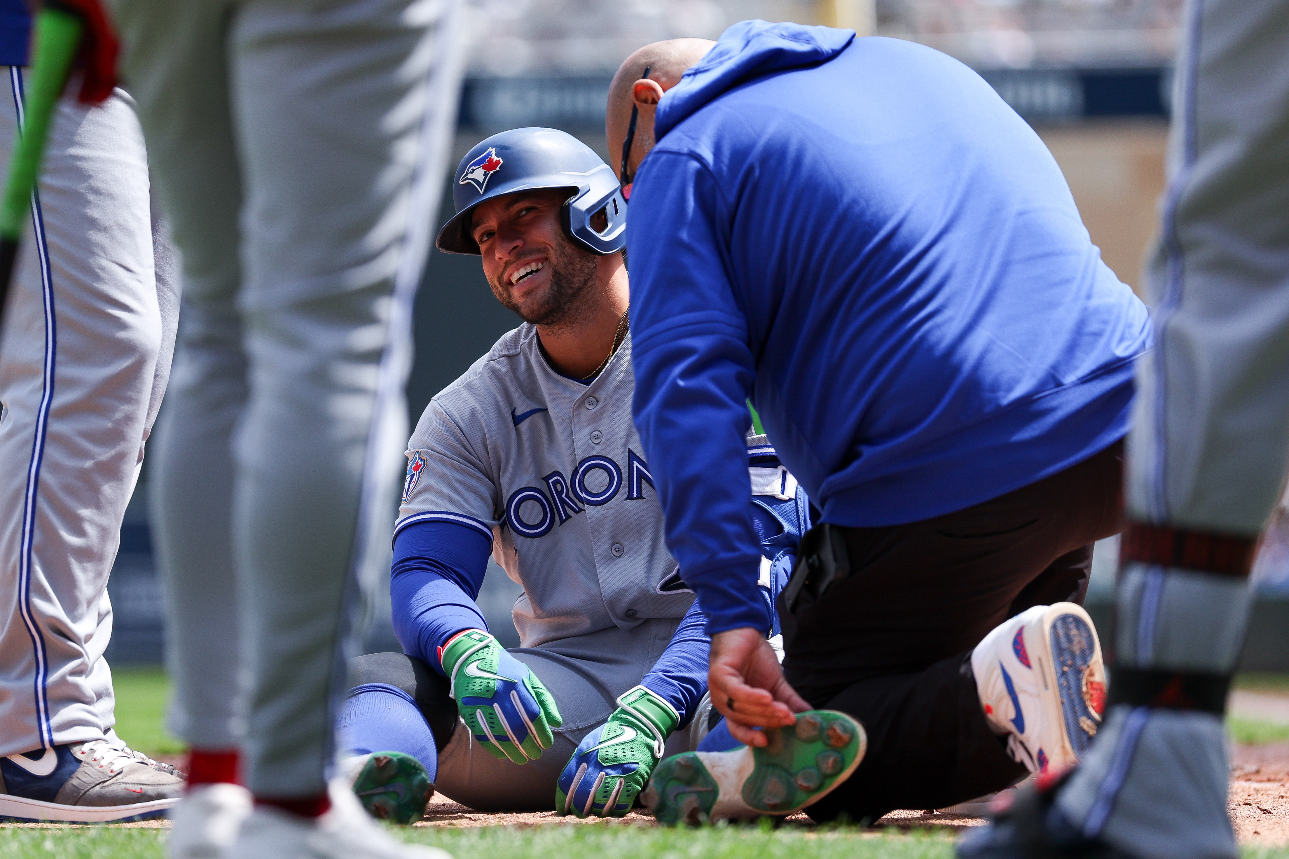 Toronto Blue Jays designated hitter George Springer is tended to after getting hit by a pitch during the third inning of a baseball game against the Minnesota Twins, Saturday, May 2, 2026, in Minneapolis. 
