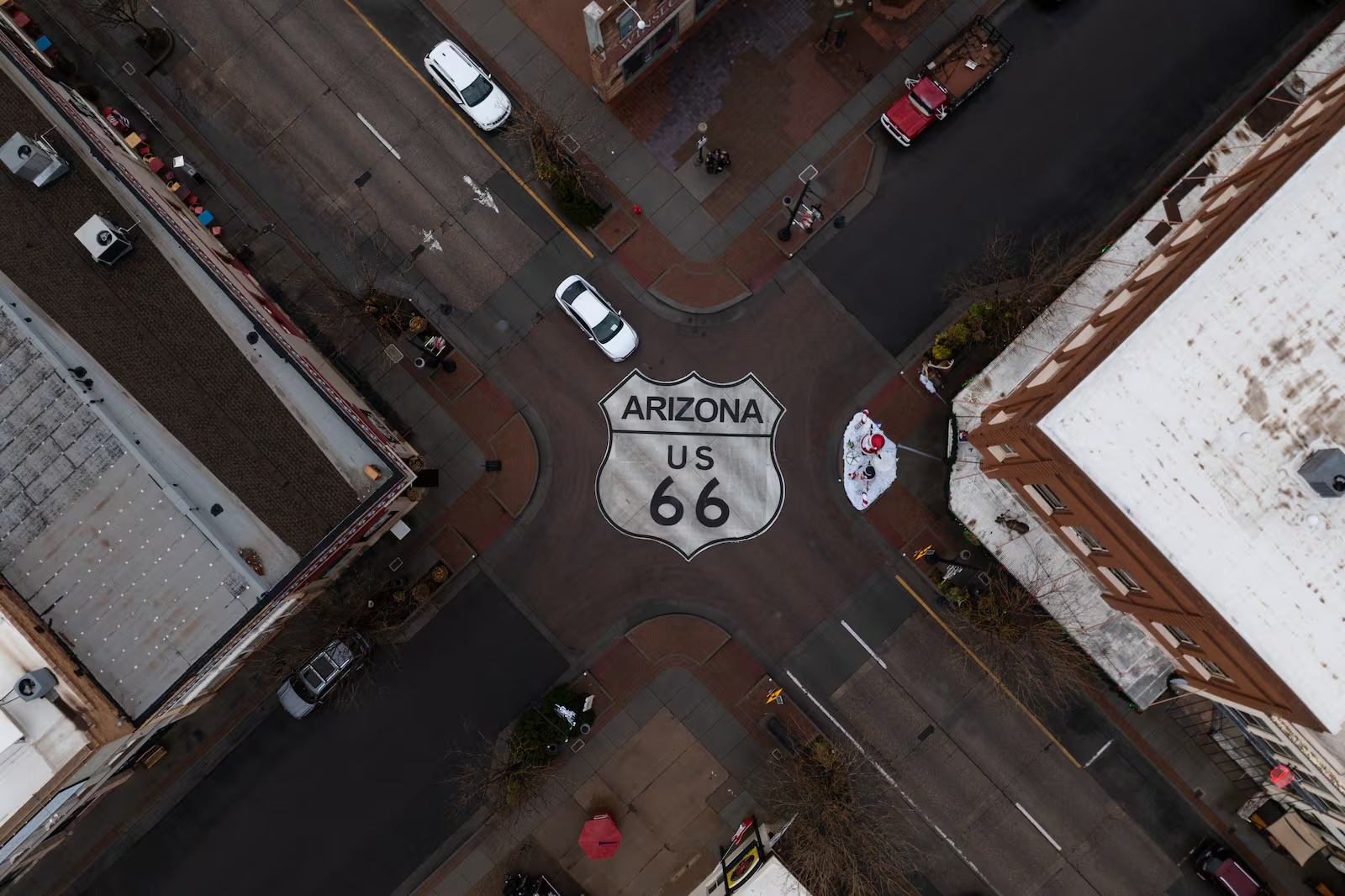 Motorists travel through an intersection marked with a U.S. 66 shield in Winslow, Ariz., a town on the historic highway, Nov. 20, 2025.