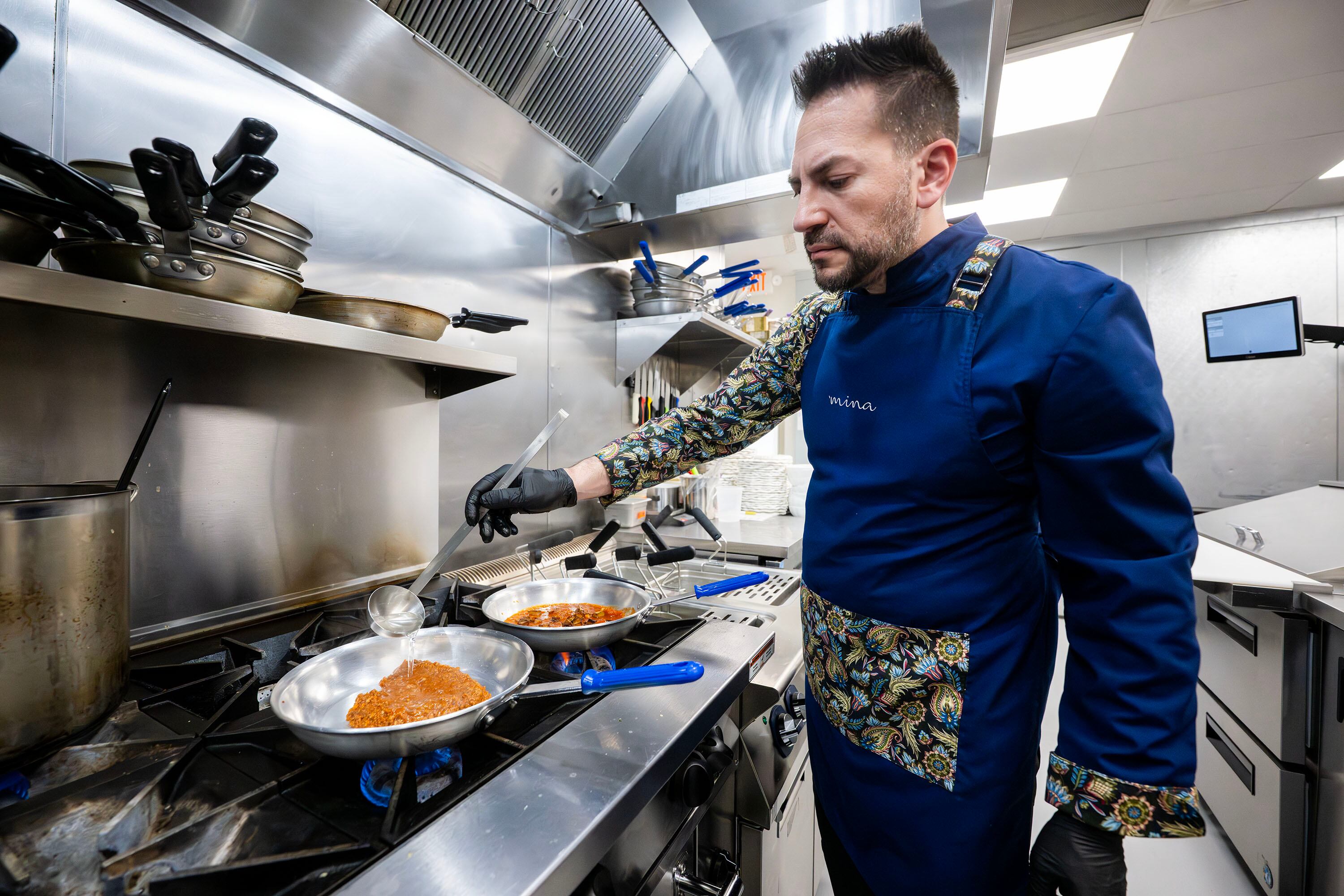 Executive chef Leonardo Le Mura adds water to the pan as he begins preparing a dish at Mina, a new Sicilian-inspired Italian restaurant, in Salt Lake City on Wednesday. Guests are greeted with a mural inspired by Le Mura's hometown as they walk into the restaurant.