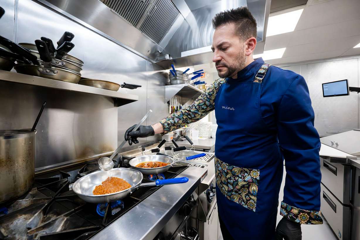 Executive chef Leonardo Le Mura adds water to the pan as he begins preparing a dish at Mina, a new Sicilian-inspired Italian restaurant, in Salt Lake City on Wednesday. Guests are greeted with a mural inspired by Le Mura's hometown as they walk into the restaurant.