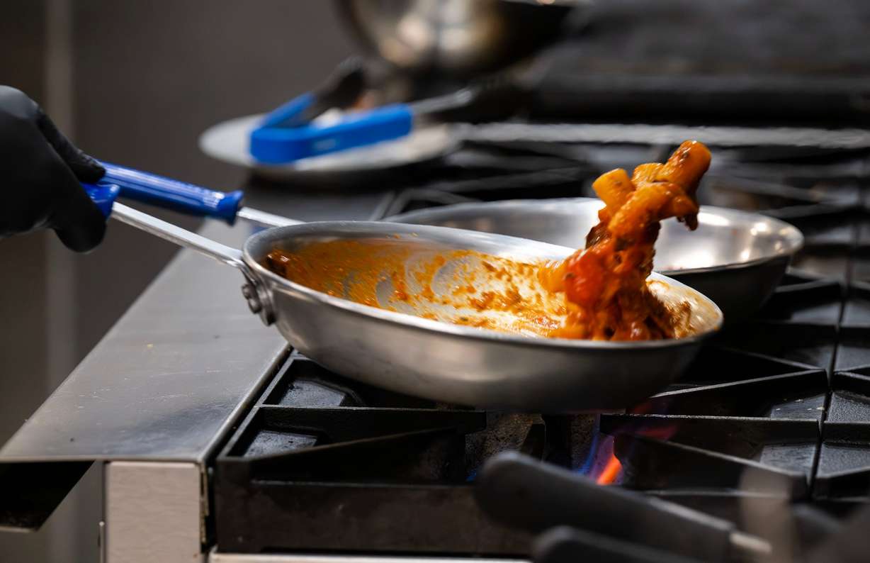 Executive chef Leonardo Le Mura flips the pasta as he prepares a dish at Mina, a new Sicilian-inspired Italian restaurant, in Salt Lake City on Wednesday. The restaurant also offers gluten-free options.