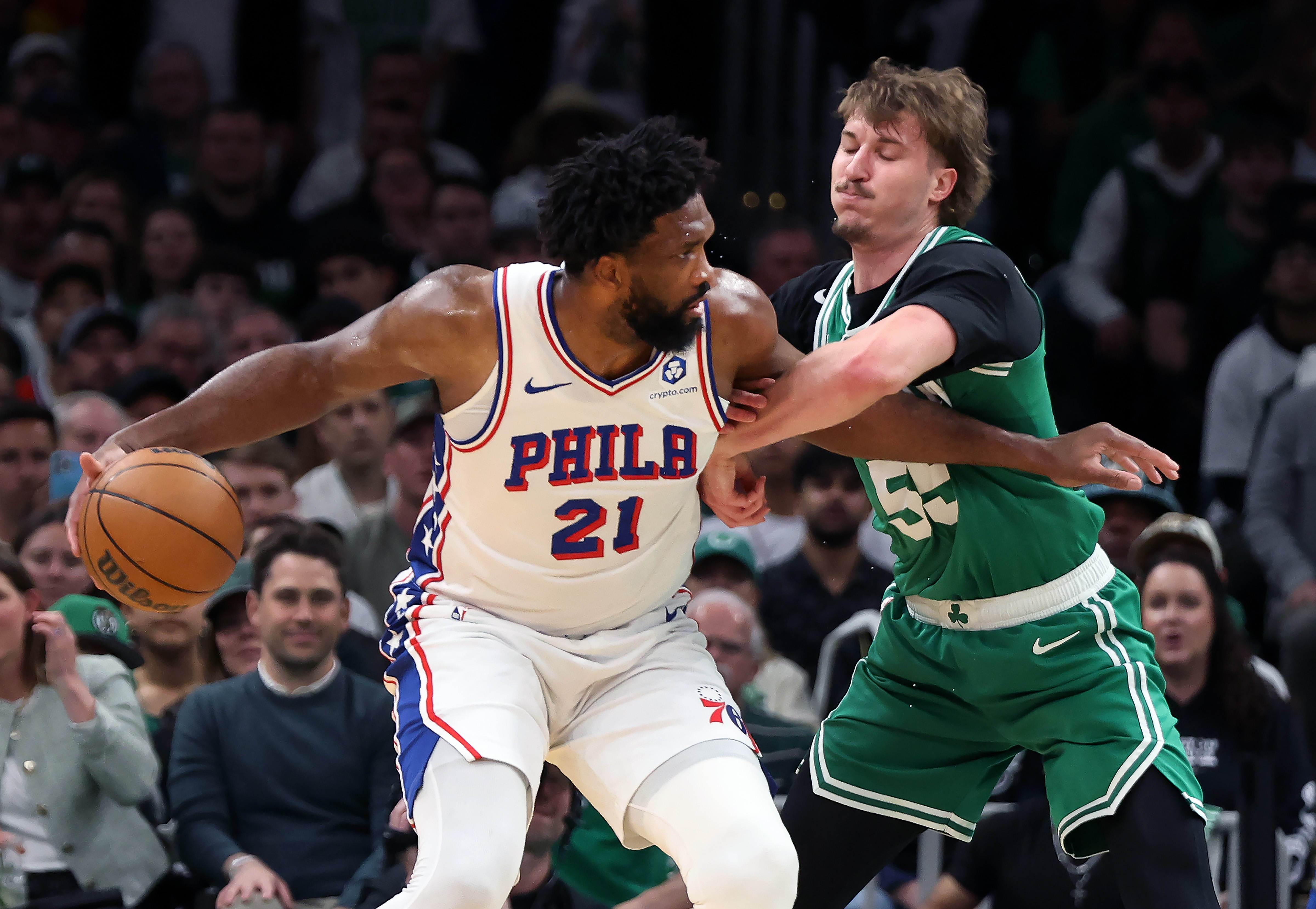 Boston Celtics' Jayson Baylor Scheierman (right) defends agianst Philadelphia 76ers' Joel Embiid (left) during the first half of Game 7 in a first-round NBA basketball playoffs series, Saturday, May 2, 2026 in Boston. 