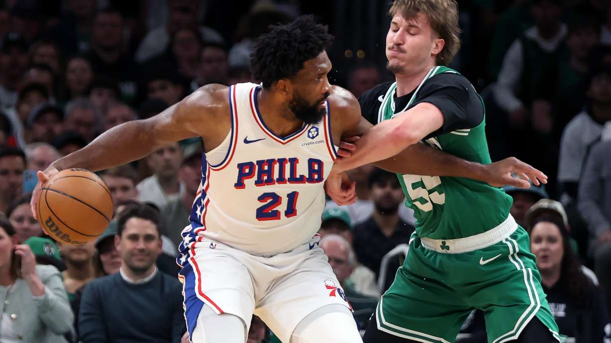 Boston Celtics' Jayson Baylor Scheierman (right) defends agianst Philadelphia 76ers' Joel Embiid (left) during the first half of Game 7 in a first-round NBA basketball playoffs series, Saturday, May 2, 2026 in Boston.