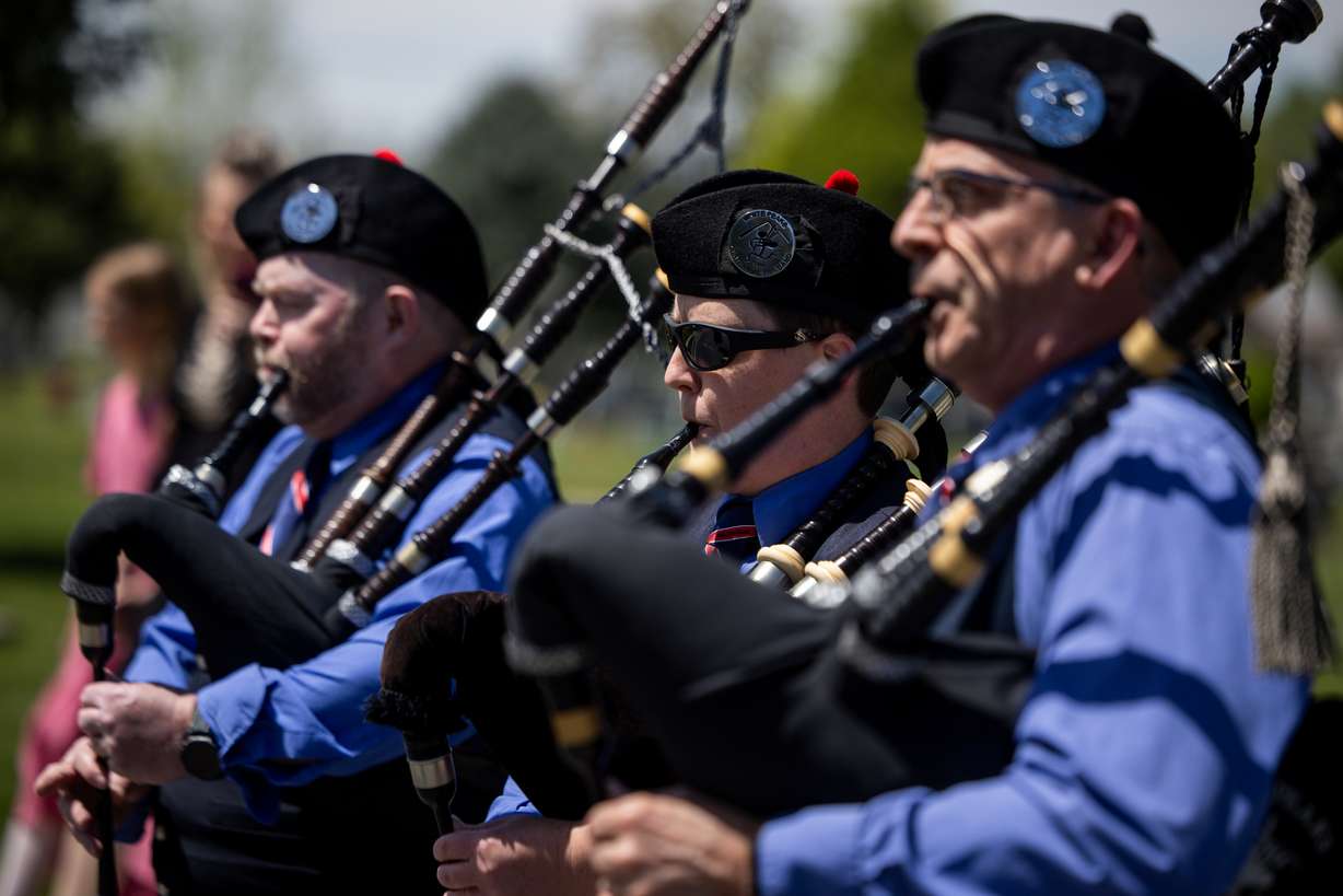 The White Peaks Centennial Pipe Band leads the hearse carrying the casket of Alan Osmond into the Spanish Fork City Cemetery in Spanish Fork on Saturday. The graveside ceremony combined solemn tradition with unexpected spectacle.