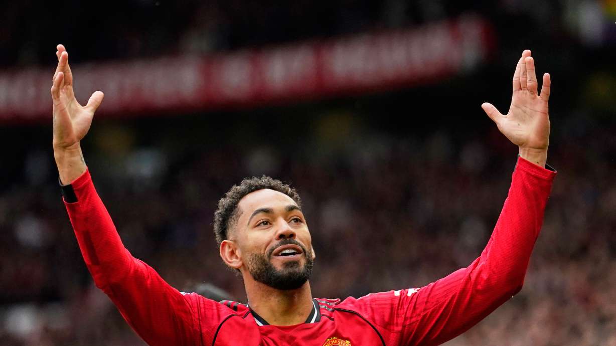 Manchester United's Matheus Cunha celebrates after scoring his side's opening goal during the English Premier League soccer match between Manchester United and Liverpool in Manchester, England, Sunday, May 3, 2026.