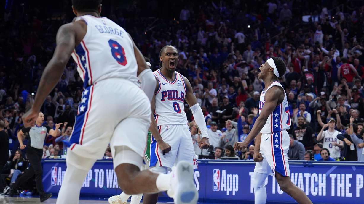 Philadelphia 76ers' Tyrese Maxey (0), Vj Edgecombe (77) and Paul George (8) celebrate during the second half of Game 6 in a first-round NBA basketball playoff series against the Boston Celtics Thursday, April 30, 2026, in Philadelphia.
