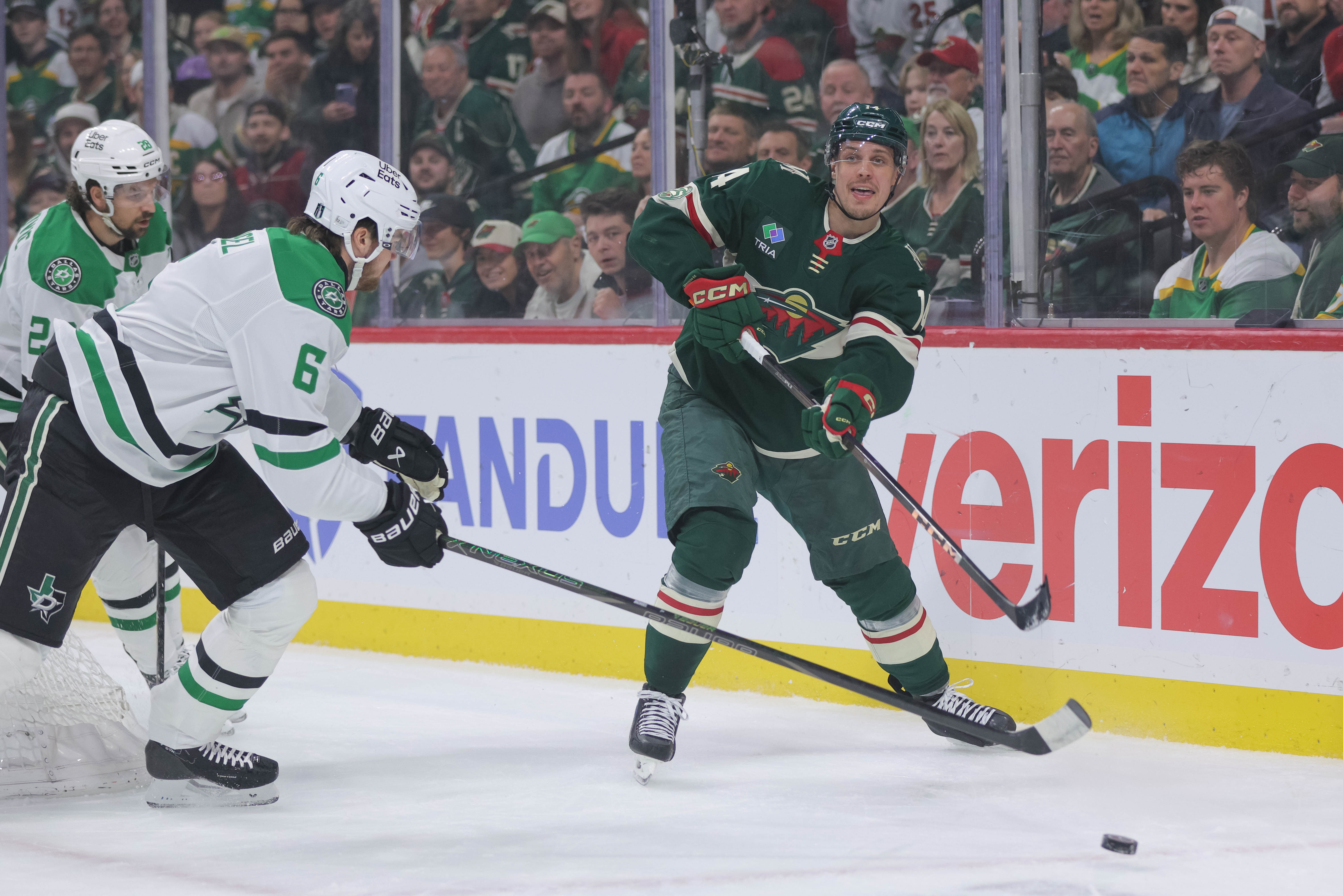 Minnesota Wild center Joel Eriksson Ek (14) passes while Dallas Stars defenseman Lian Bichsel (6) defends during the first period of Game 6 in the first round of the NHL hockey Stanley Cup playoff series Thursday, April 30, 2026, in St. Paul, Minn. 