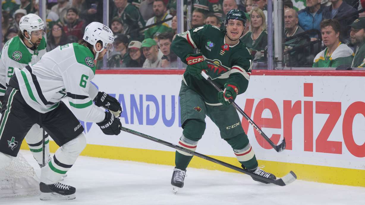 Minnesota Wild center Joel Eriksson Ek (14) passes while Dallas Stars defenseman Lian Bichsel (6) defends during the first period of Game 6 in the first round of the NHL hockey Stanley Cup playoff series Thursday, April 30, 2026, in St. Paul, Minn.