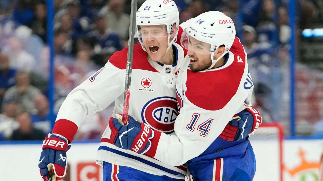 Montréal Canadiens center Nick Suzuki (14) celebrates his goal against the Tampa Bay Lightning with defenseman Kaiden Guhle (21) during the first period in Game 7 of an NHL hockey Stanley Cup first-round playoff series, Sunday, May 3, 2026, in Tampa, Fla.