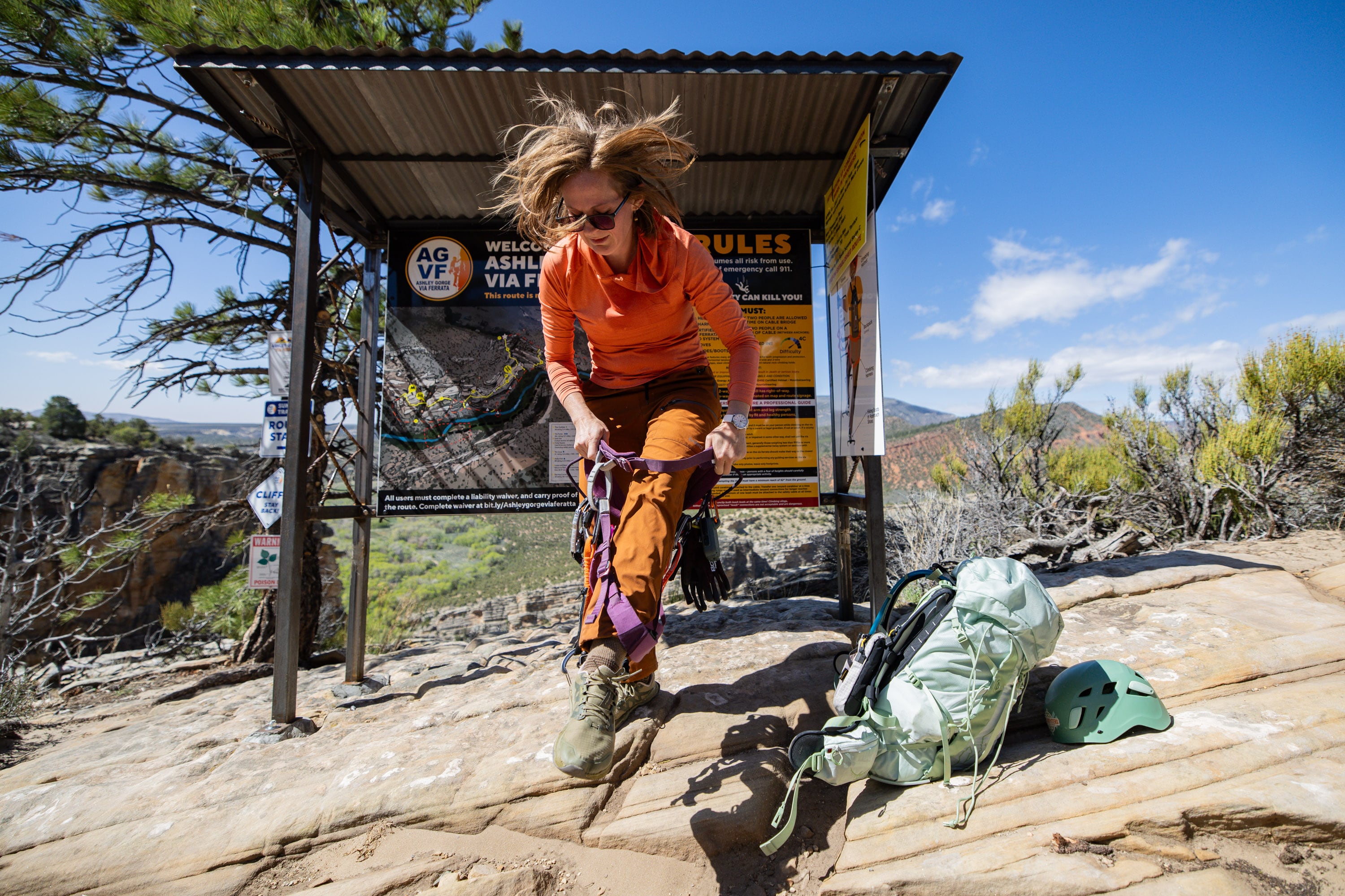 Guide and owner of Dyno Outfitters Amber Toler puts on her harness in strong winds before guiding Carolyn Jane Norris, from Vernal, as they climb the Ashley Gorge Via Ferrata, Utah's first public via ferrata and the longest in the United States, offering a "hard-iron" climbing experience with steel rungs, cables and bridges, in Vernal on April 22.