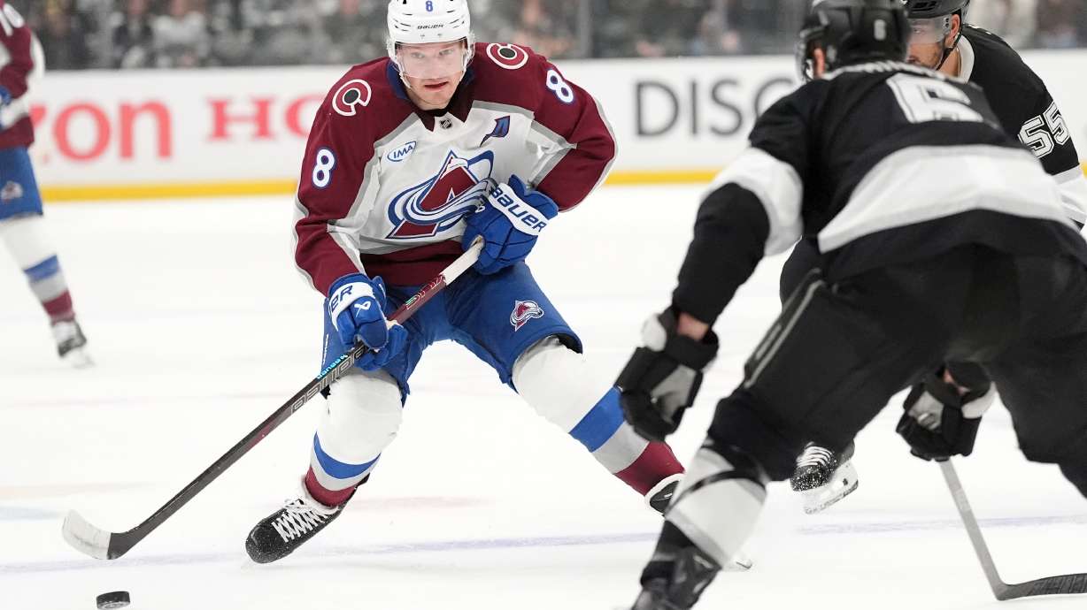 Colorado Avalanche's Cale Makar (8) brings the puck across the blue line against Los Angeles Kings during the first period of Game 4 in the first round of an NHL hockey Stanley Cup playoff series Sunday, April 26, 2026, in Los Angeles.
