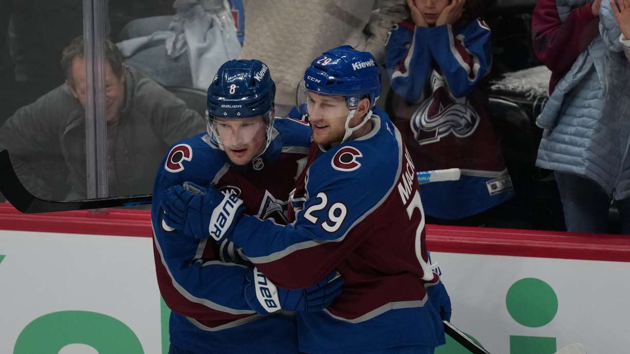 Colorado Avalanche defenseman Cale Makar, left, congratulates center Nathan MacKinnon after he scored a goal against the Minnesota Wild in the third period of Game 1 of an NHL hockey Stanley Cup second-round playoff series Sunday, May 3, 2026, in Denver.