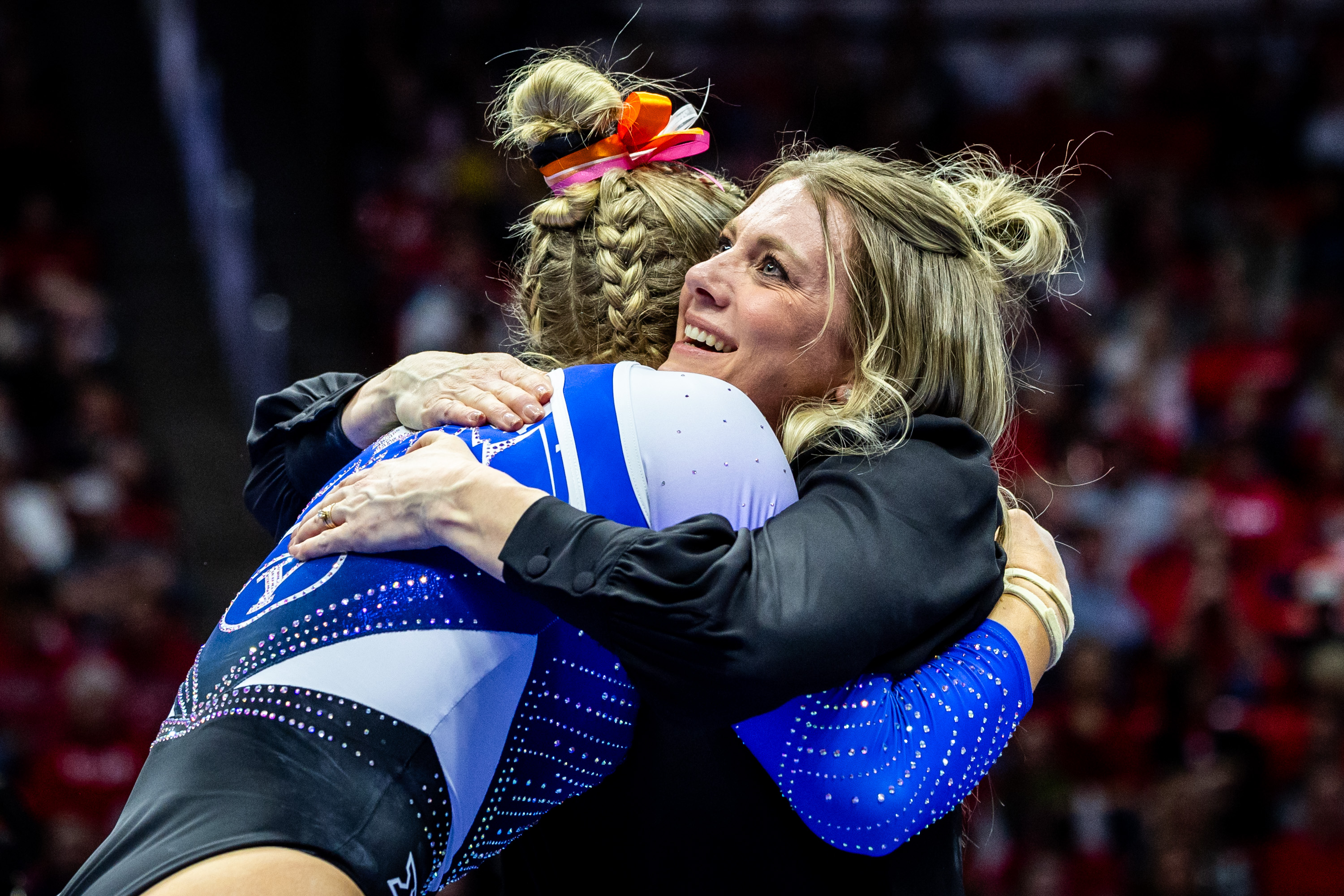 BYU women’s gymnastics associate head coach Natalie Broekman hugs BYU’s Chloee Hoke after she performed on the balance beam as BYU competes in the NCAA regional semifinals for gymnastics at the Jon M. Huntsman Center in Salt Lake City on Thursday, April 3, 2025.