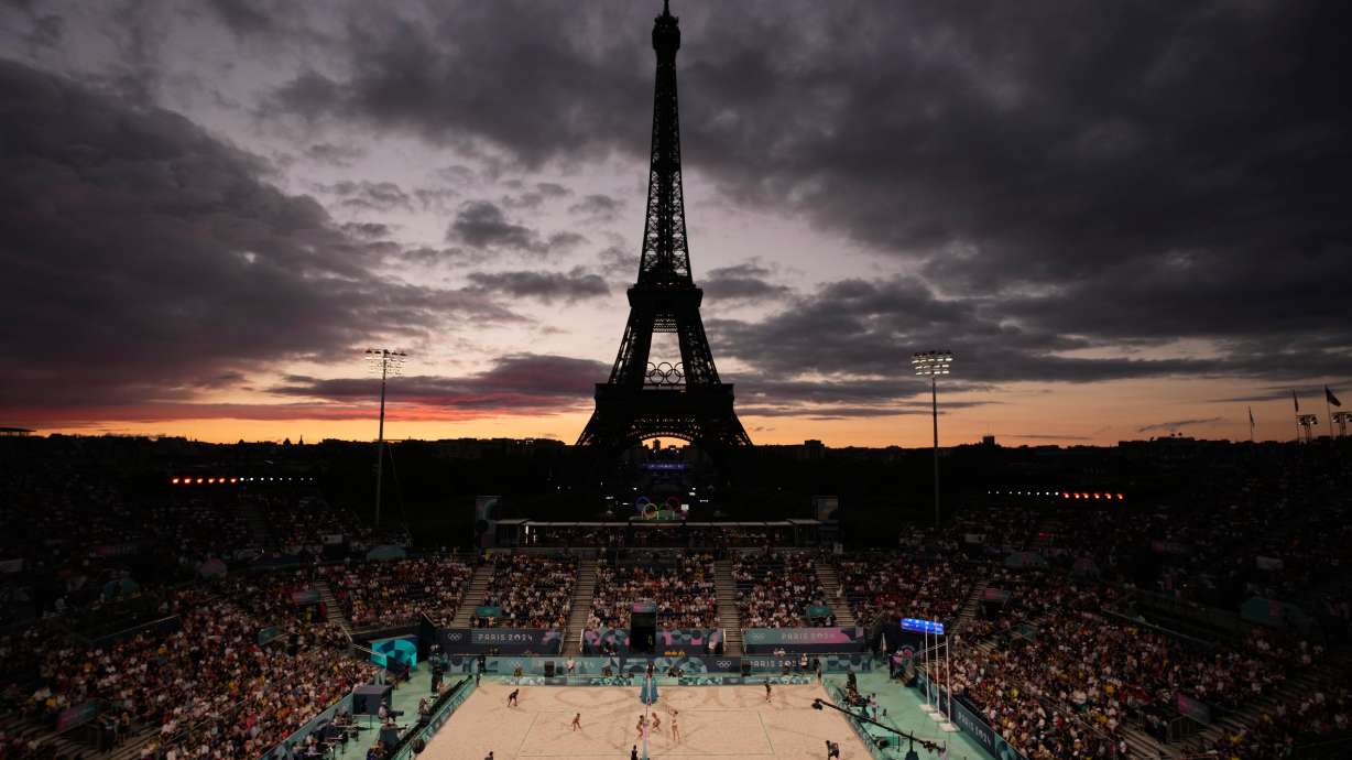 The Eiffel Tower is seen in the background during play in the women's beach volleyball bronze medal match between Australia, left, and Switzerland, at the 2024 Summer Olympics, Aug. 9, 2024, in Paris.