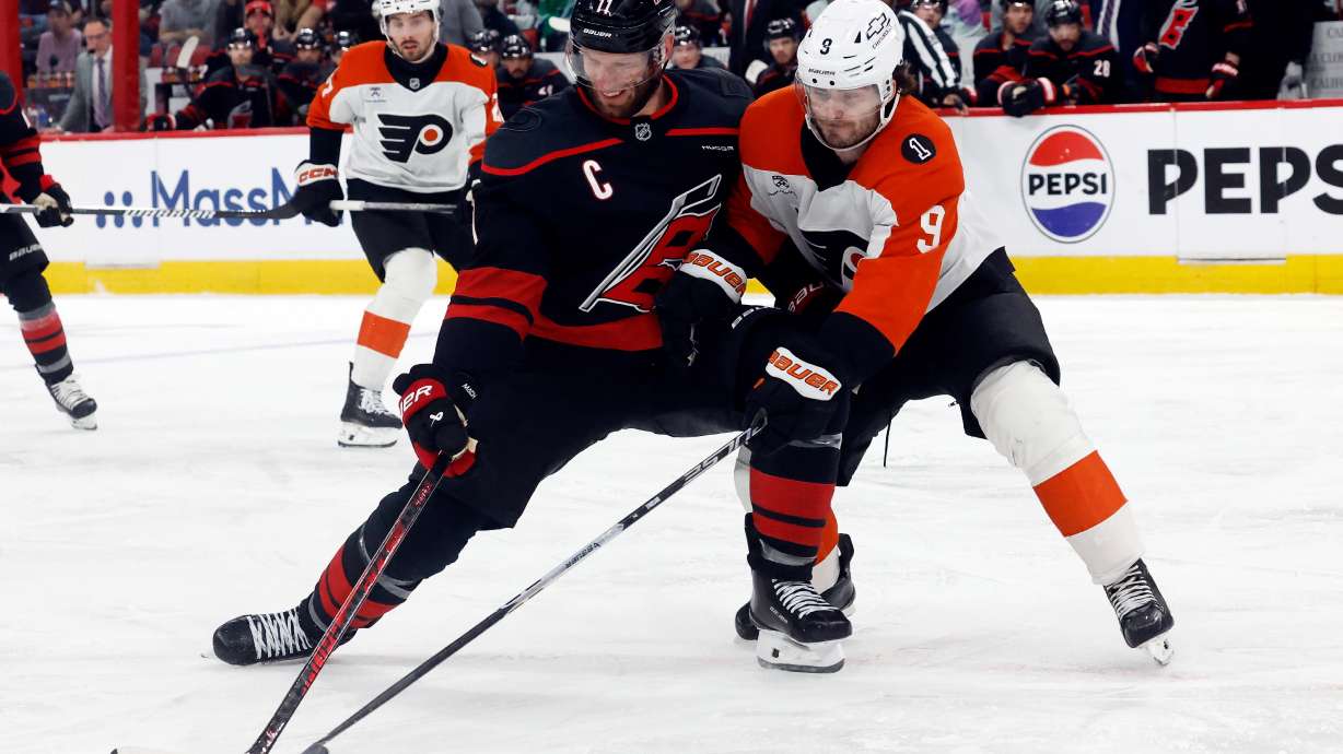 Carolina Hurricanes' Jordan Staal (11) battles Philadelphia Flyers' Jamie Drysdale (9) for the puck during the second period of Game 2 of an NHL hockey Stanley Cup second-round playoff series in Raleigh, N.C., Monday, May 4, 2026.