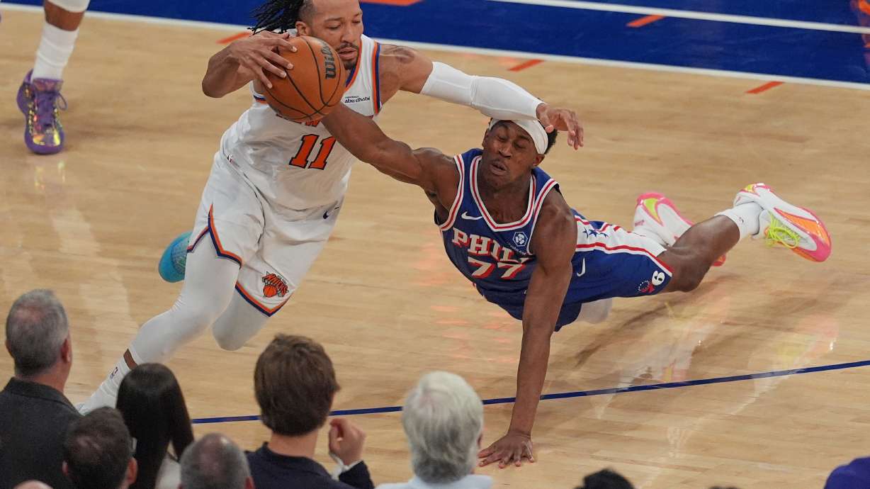 Philadelphia 76ers' Vj Edgecombe, right, fouls New York Knicks' Jalen Brunson during the first half of Game 1 in a second-round NBA basketball playoffs series Monday, May 4, 2026, in New York.