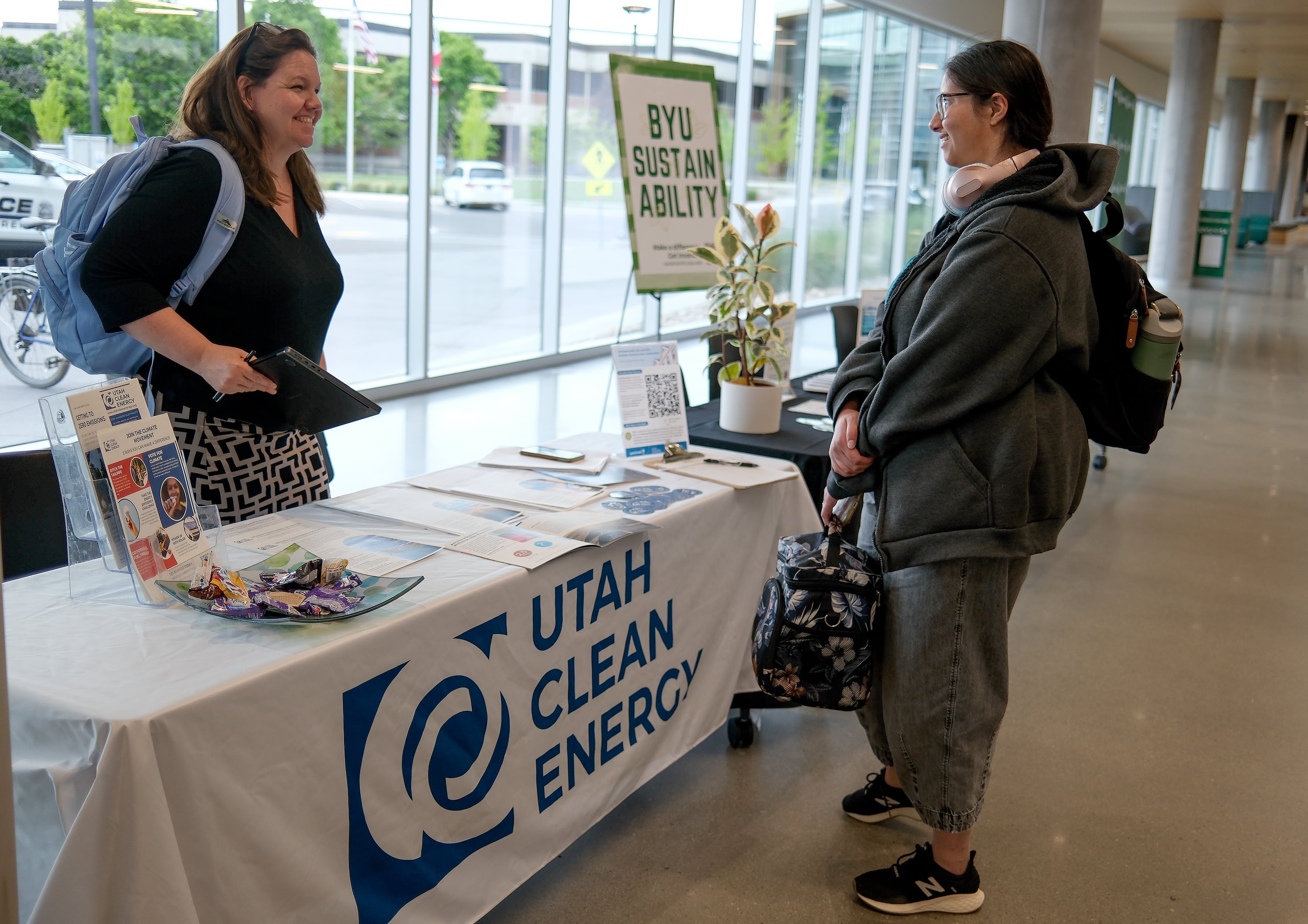 Brandy Smith, Utah Clean Energy communications director, talks with Leesa Crump at An Evening with Sen. John Curtis: Bringing People Together for Constructive Conversation about Climate Change, at the Scott C. Keller Business Building at UVU in Orem on Monday.