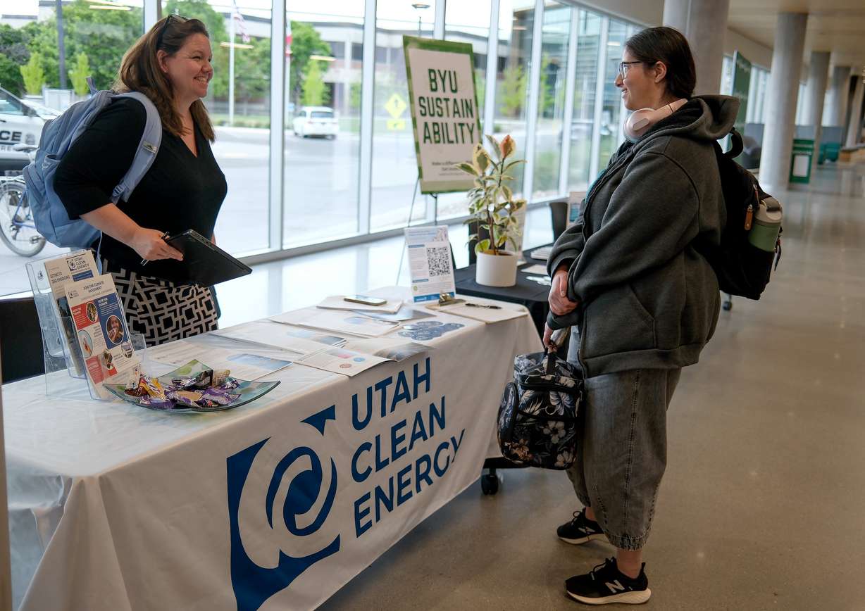 Brandy Smith, Utah Clean Energy communications director, talks with Leesa Crump at An Evening with Sen. John Curtis: Bringing People Together for Constructive Conversation about Climate Change, at the Scott C. Keller Business Building at UVU in Orem on Monday.