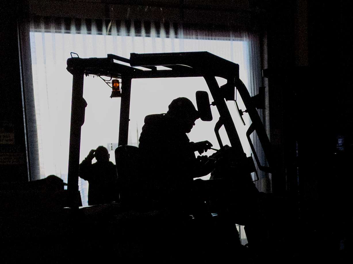 Boxes of food are loaded and unloaded at the Utah Food Bank in Salt Lake City on Wednesday.