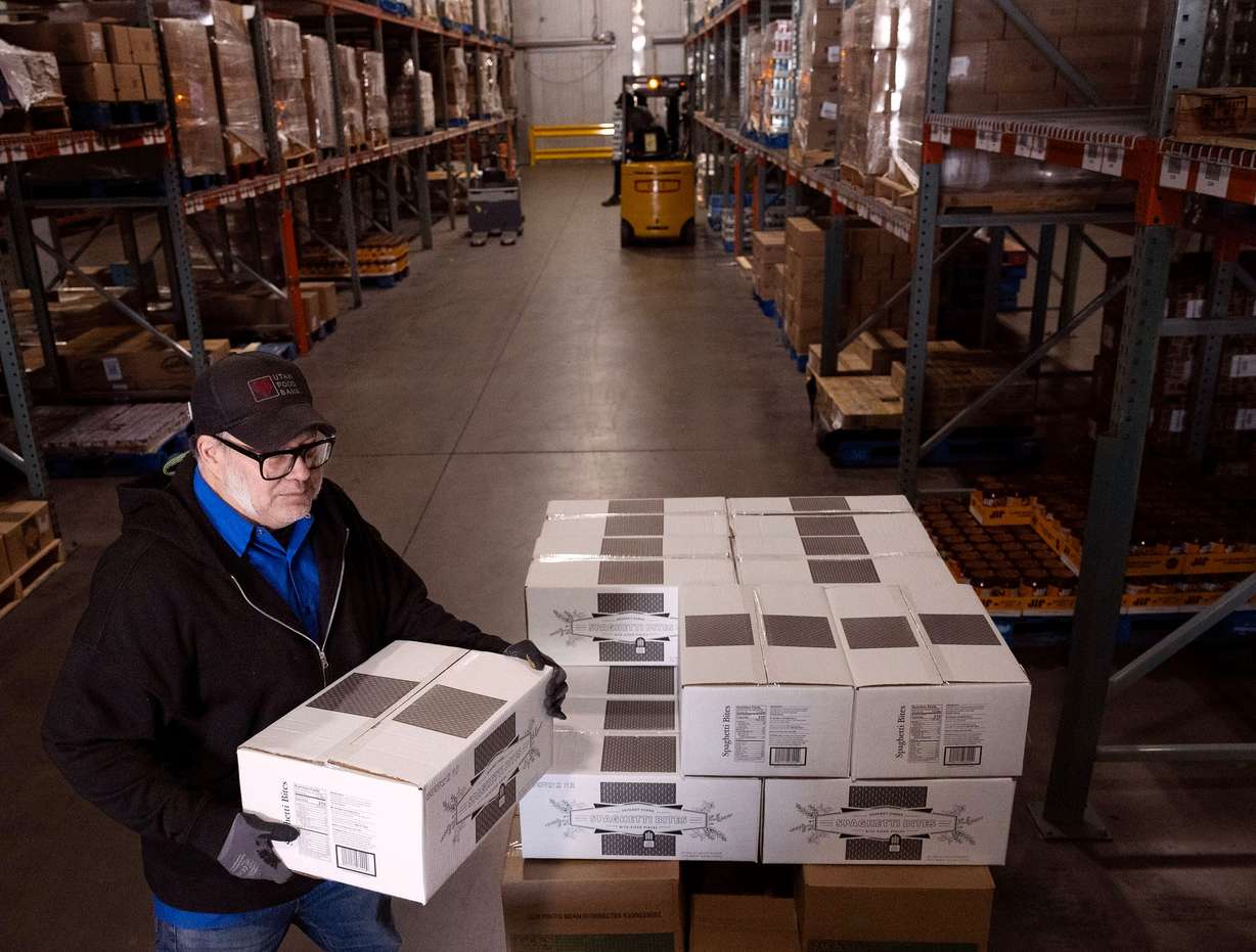 Warehouse associate Douglass Styer unloads boxes of spaghetti bites at the Utah Food Bank in Salt Lake City on Wednesday.