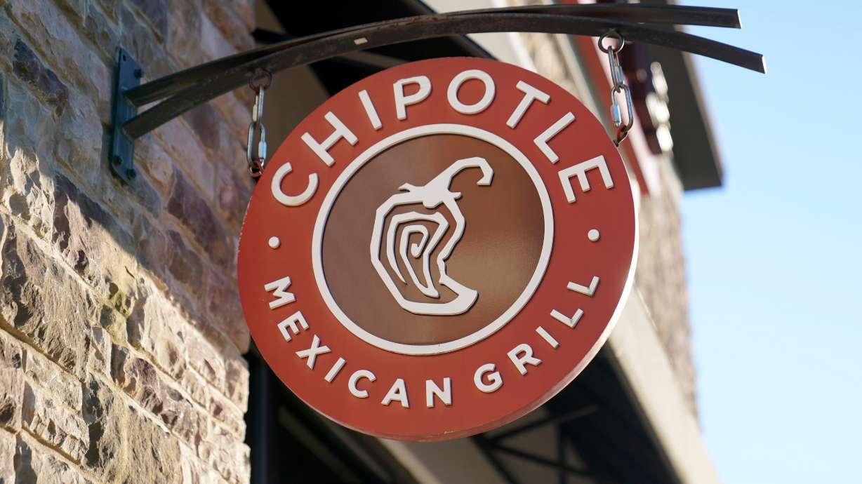 A Chipotle Mexican Grill logo hangs outside a restaurant location, Dec. 20, 2022, in Westwood, Mass. In 2026, Cinco de Mayo lines up with Taco Tuesday for a few extra promotions.