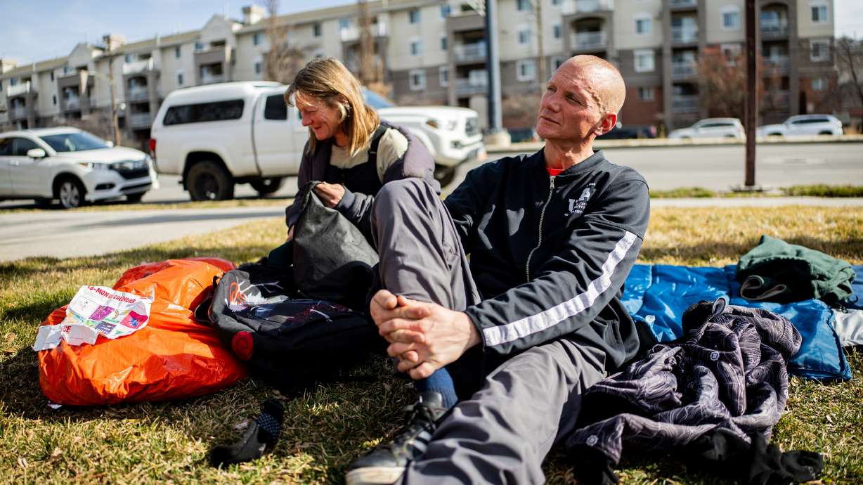 Ashley Miller, left, and Edwin Mangum, right, people experiencing homelessness, sit at Pioneer Park in Salt Lake City on Feb. 3. Utah already released some data showing a slight decrease in overall statewide homelessness, but newly released data highlights how decreases were felt across all three reporting regions.