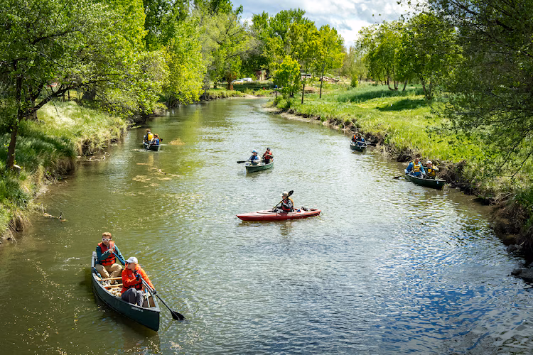 Volunteers paddle the Jordan River on April 22, 2026, as the Jordan River Commission hosted an Earth Day river cleanup.
