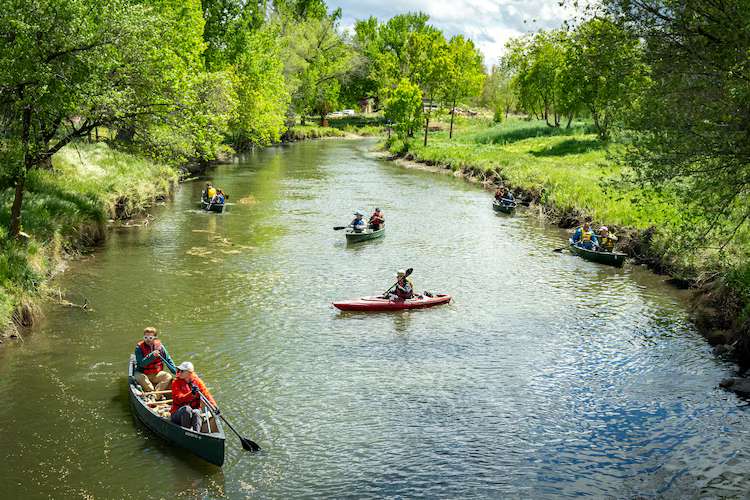 Volunteers paddle the Jordan River on April 22, 2026, as the Jordan River Commission hosted an Earth Day river cleanup.