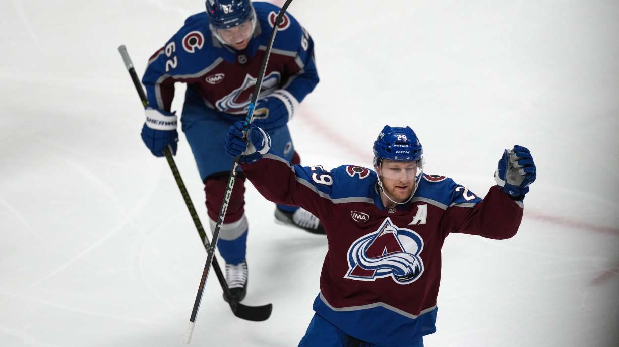 Colorado Avalanche center Nathan MacKinnon, front, and left wing Artturi Lehkonen react after center Martin Necas scored a goal against the Minnesota Wild in the first period of Game 2 of an NHL hockey Stanley Cup second-round playoff series Tuesday, May 5, 2026, in Denver.